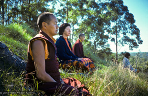 (15969_sl.JPG) Lama Yeshe, Beatrice Ribush, and Lama Zopa Rinpoche in meditation. On Saka Dawa (the celebration of Buddha's birth, enlightenment, and death), Lama Yeshe asked everyone to come outside after a Guru Puja for a meditation on the hill behind the gompa. Chenrezig Institute, Australia, May 25, 1975. Photo by Wendy Finster.